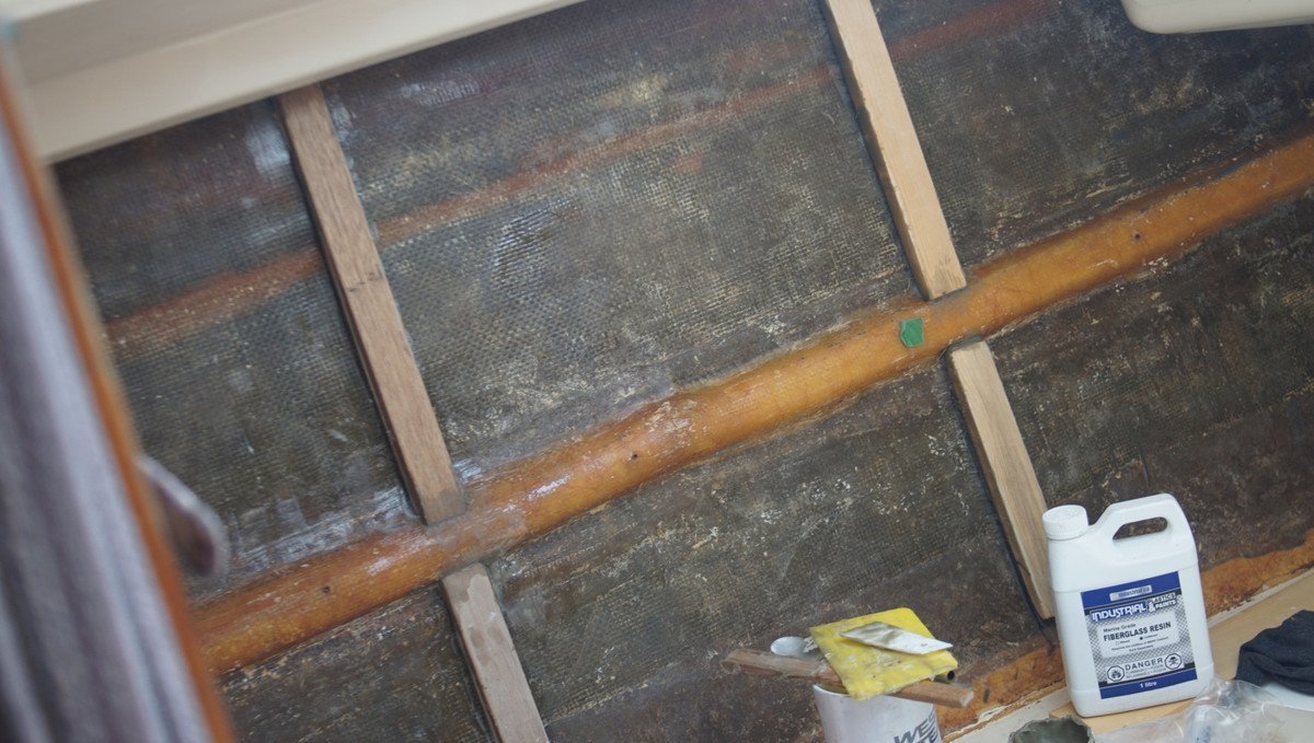 a photo of the v-berth with wooden scaffolding along the hull, and a view of the bad resin