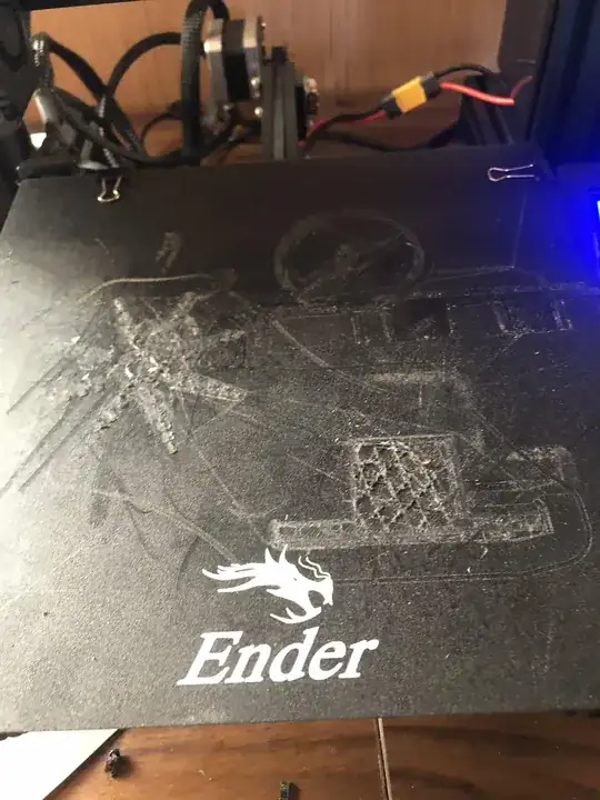 Photo of a print bed with some of the bottom layers of a print stuck to the bed Photo of a print bed with some of the bottom layers of a print stuck to the bed