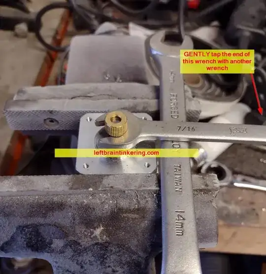 Using a couple of wrenches to pop the brass gear off of the motor Using a couple of wrenches to pop the brass gear off of the motor