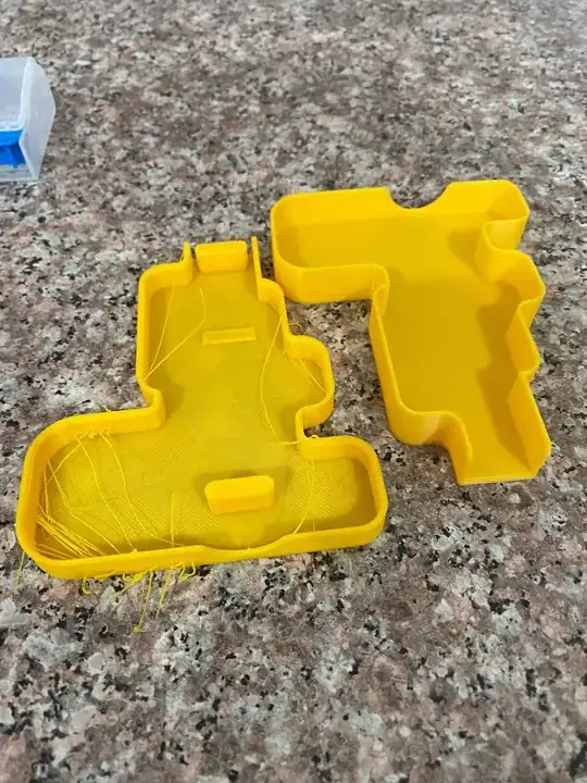 Photo of two printed models, the left model has stringing while the right one doesn't Photo of two printed models, the left model has stringing while the right one doesn't