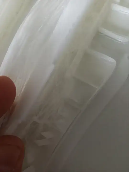 Closeup view of a printed model with lots of filament 'threads'