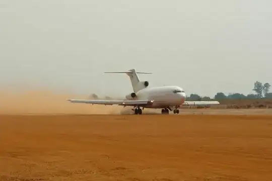Photo of a 727 taking off from a dirt strip