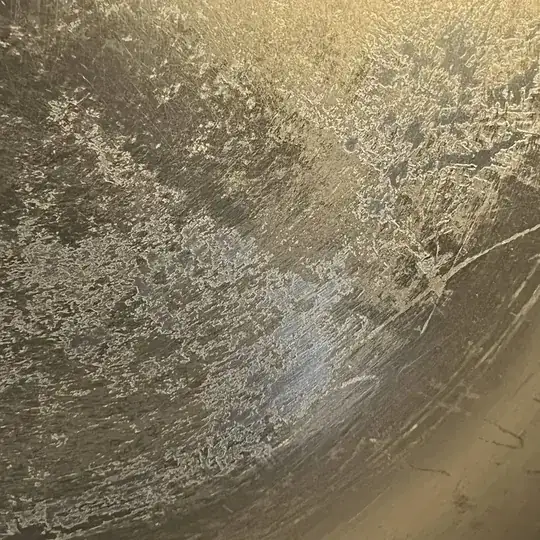 A close-up of what's looking weird to me: it looks like a layer on top of the metal is peeling off.