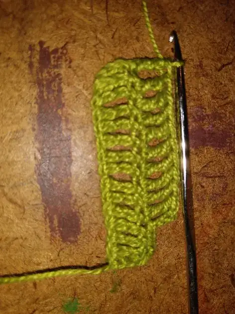 One row of 15 treble stitches under another with 11.