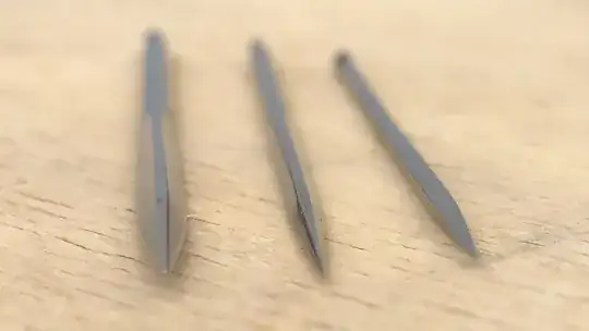 close-up photography of three-edges needles