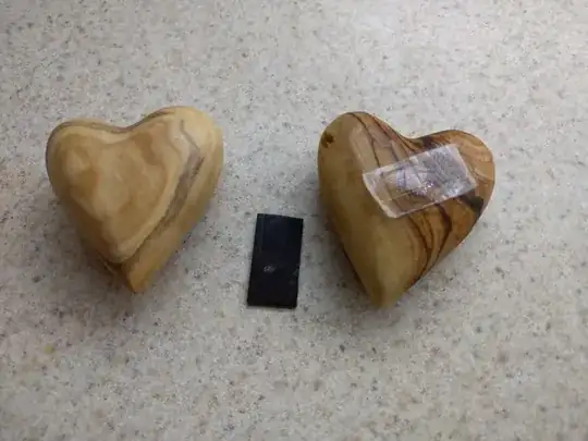 Two small wooden hearts and a smaller magnet