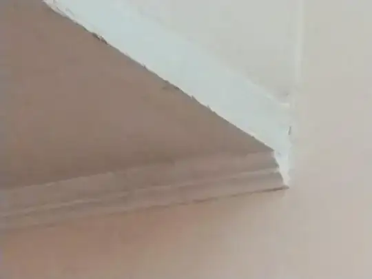 Picture of junction over stairwell between lower ceiling, adjacent wall, and wall above steps