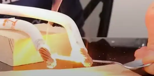 Mehdi holding the bowl, while part of the handle glows red hot