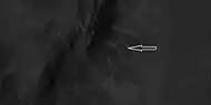 Close view of ridges from previous HiRISE image.  Arrow indicates an X-shaped ridge.