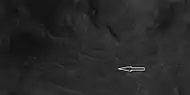 Close view of central section of Auki showing ridges with arrow.  Image is an enlargement of a previous HiRISE image.