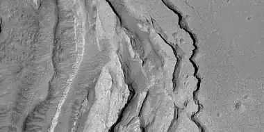 Tilted layers formed when ground collapsed, as seen by HiRISE under HiWish program
