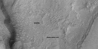 Brain terrain is forming from the breakdown of upper plains unit, as seen by HiRISE under HiWish program. Arrow points to a place where fractures are forming that will turn into brain terrain.