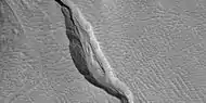 Close view of channel in gully showing streamlined forms, as seen by HiRISE under HiWish program