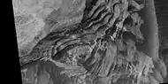 Close view of layers in Schiaparelli Crater, as seen by HiRISE under HiWish program. Dark sand is visible on some layers.