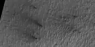 Close view of defrosting, as seen by HiRISE under HiWish program. Gas and dark dust is probably being blown out of ground and then carried by winds toward the Northwest.