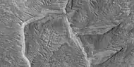 Ridges, some of which seem to have layers. Picture taken with HiRISE under HiWish program.