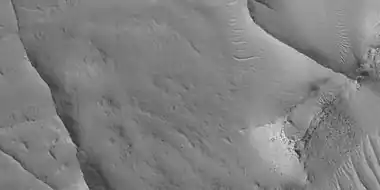 Close view of ridges, as seen by HiRISE under HiWish program. This is an enlargement of a previous image.  A small mesa in the image displays layers.