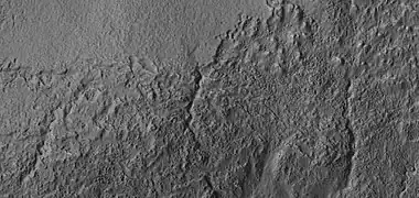 Close view of small channels that seem to originate in a mantle layer,  as seen by HiRISE under HiWish program
