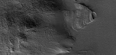 Close view of exhumed crater, as seen by HiRISE under HiWish program.  This crater is and was under a set of dipping layers.