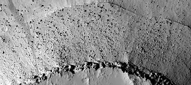 Close view of mesa, as seen by HiRISE.  House-sized boulders are present in abundance.