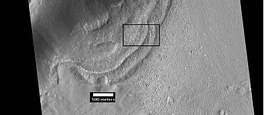 Context for the next image of the end of a flow feature or glacier.  Location is Hellas quadrangle.