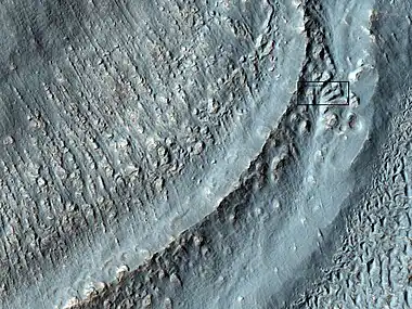 Close-up of the area in the box in the previous image.  This may be called by some the terminal moraine of a glacier.  For scale, the box shows the approximate size of a football field.  Image taken with HiRISE under the HiWish program. Location is Hellas quadrangle.