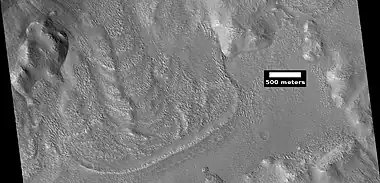 Glacier coming out of valley, as seen by HiRISE under HiWish program. Location is rim of Moreux Crater.