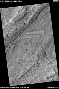 Layered features on floor of Hellas Planitia, as seen by HiRISE under HiWish program  This may be an example of honeycomb terrain that is not yet completely understood.