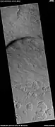 Scalloped terrain, as seen by HiRISE under HIWish program. Dust devil tracks are also visible.