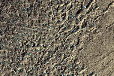 Surface of debris apron in Terra Cimmeria, as seen by HiRISE, under the HiWish program.  Colored parts may be frost deposits.