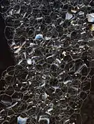 Foam of soap bubbles: four edges meet at each vertex, at angles close to 109.5°, as in two C-H bonds in methane.