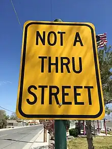A yellow sign reading "NOT A THRU STREET"